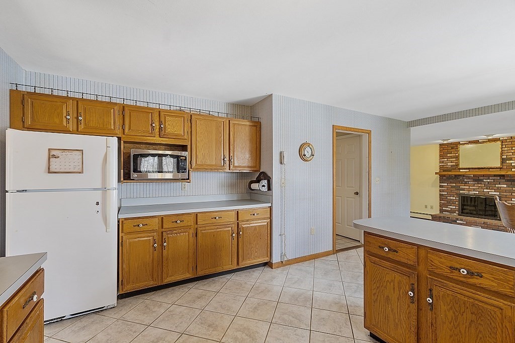 4 Horseshoe Road Windham, NH 03087 - Photo 8 of 32 a kitchen with stainless steel appliances granite countertop a refrigerator and a stove top oven