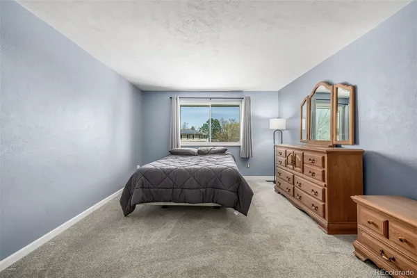 a bed room with a bed and a window