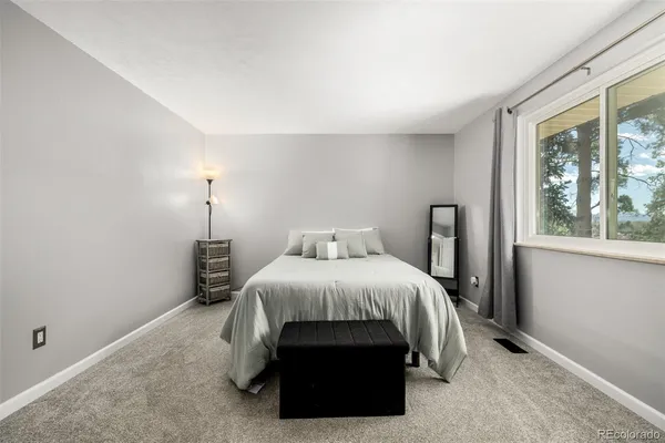 a bedroom with a bed and large window