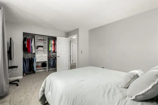 a bedroom with a bed and a desk