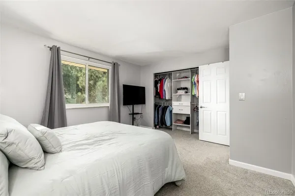 a bedroom with a bed and a television