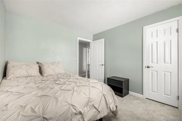 a large bed sitting in a bedroom and closet