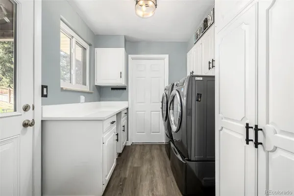 a bathroom with double vanity and a bathtub