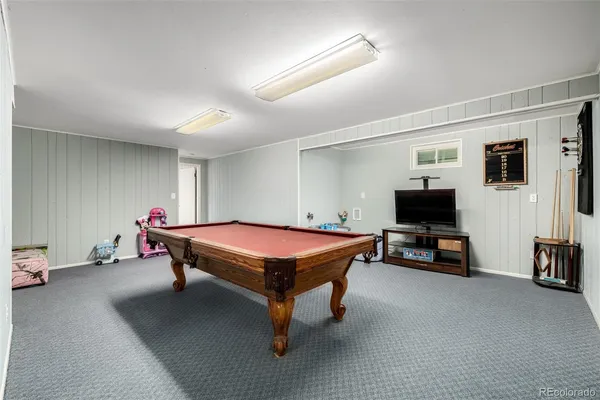 a bedroom with furniture and a flat screen tv