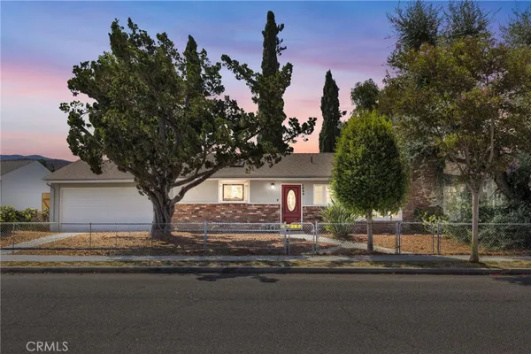 a view of a house with a yard and tree s