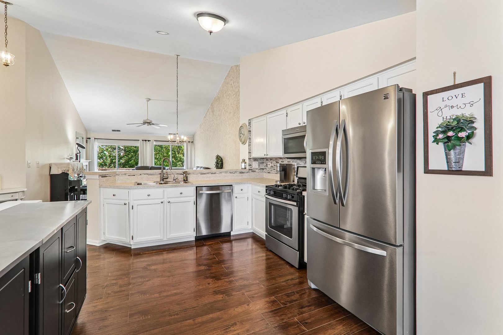 1064 Ripple Ridge Darien, IL 60561 - Photo 7 of 16 a kitchen with a refrigerator stainless steel appliances wooden floor and white cabinets