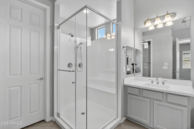 a bathroom with a tub a sink and mirror