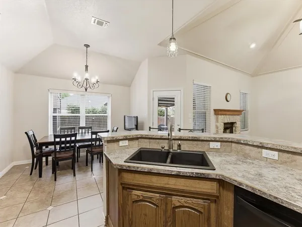 a kitchen with a sink a counter and chairs