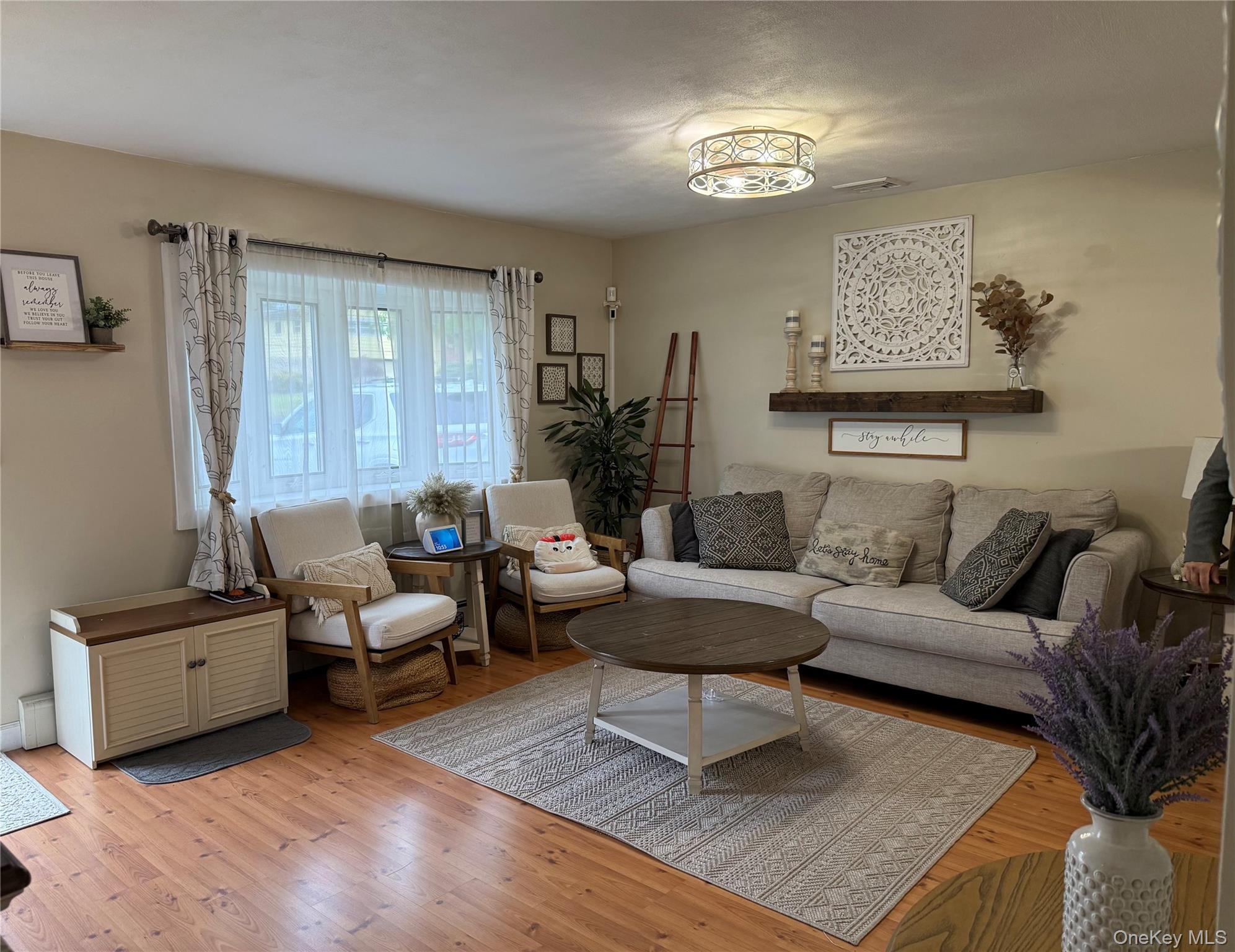 161 Hawkins Road Centereach, NY 11720 - Photo 4 of 16 a living room with furniture and a large window