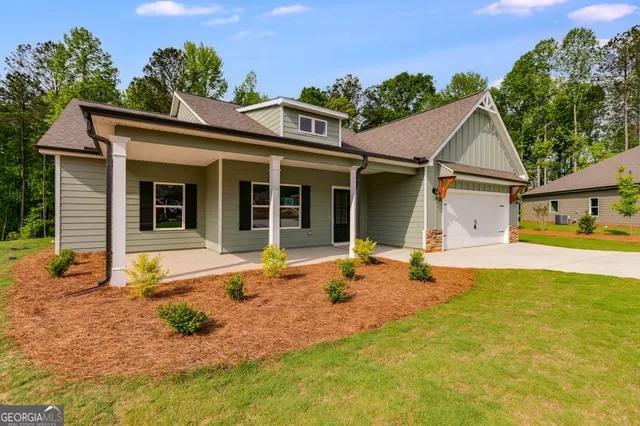 a front view of a house with a yard outdoor seating and barbeque oven