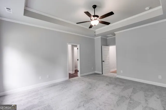 an empty room with a ceiling fan and a window