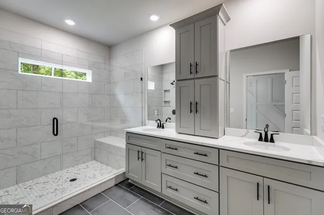 a bathroom with a shower sink double and mirror