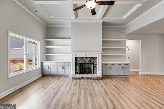 a view of a room with wooden floors and window