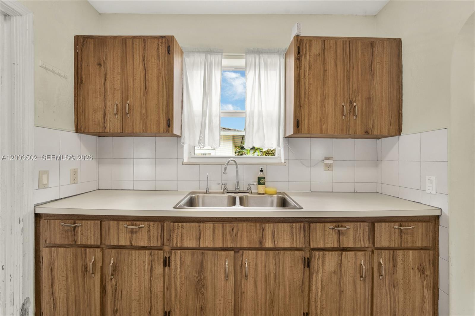 5701 Southwest 50th Terrace Miami, FL 33155 - Photo 13 of 46 a kitchen with a sink and cabinets