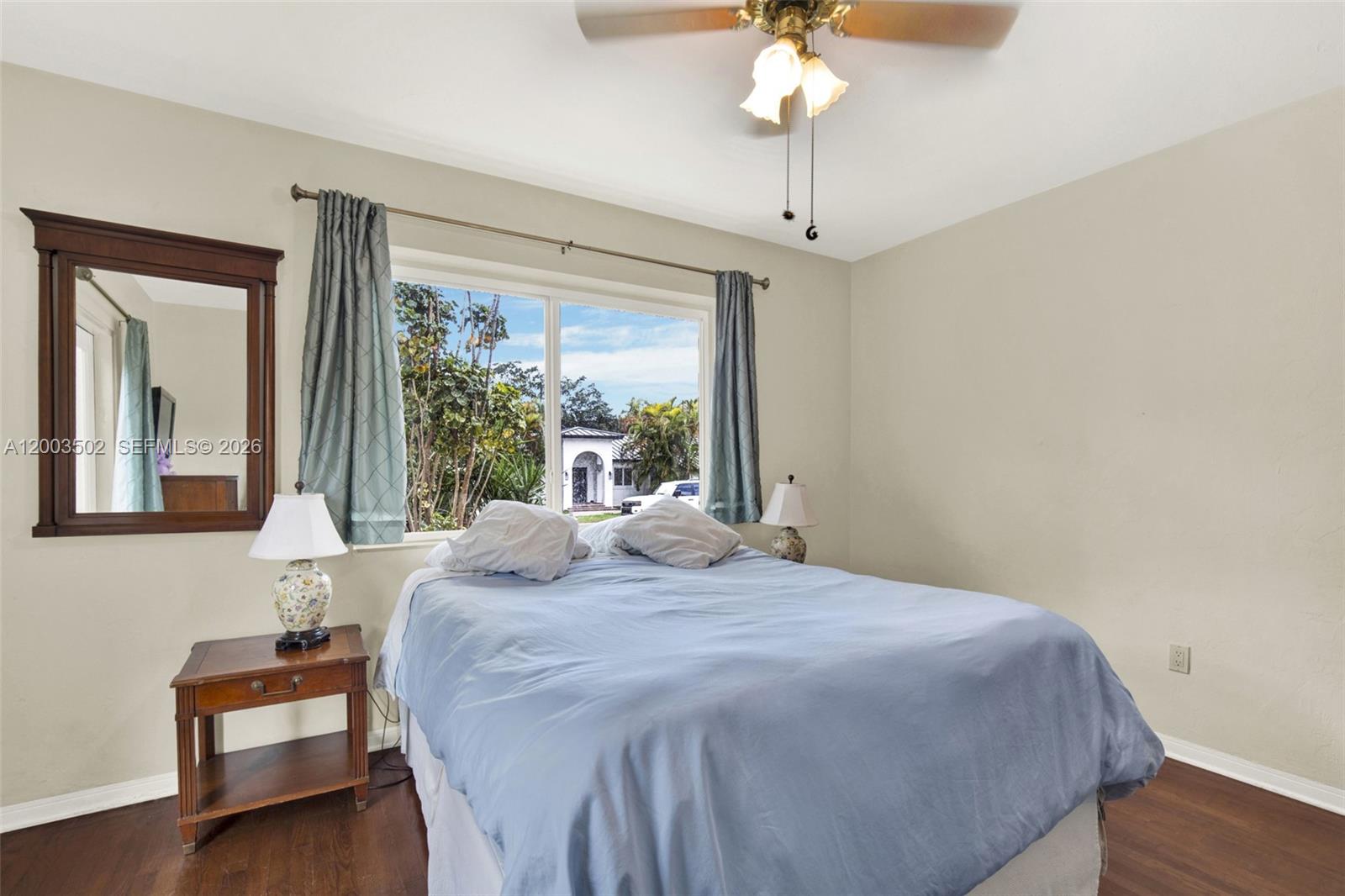 5701 Southwest 50th Terrace Miami, FL 33155 - Photo 16 of 46 a bedroom with a bed and a chandelier