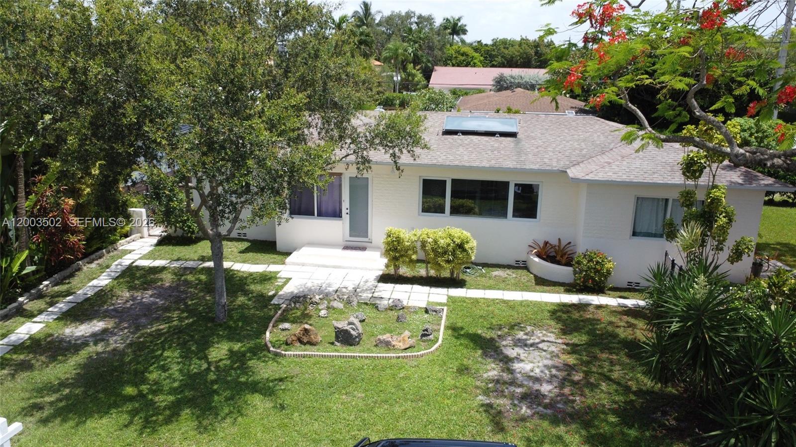 5701 Southwest 50th Terrace Miami, FL 33155 - Photo 2 of 46 a view of a house with backyard sitting area and garden