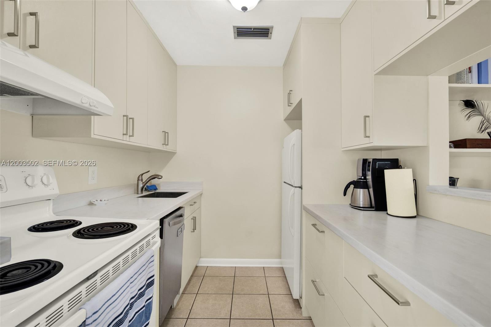 5701 Southwest 50th Terrace Miami, FL 33155 - Photo 30 of 46 a kitchen with a sink and white cabinets