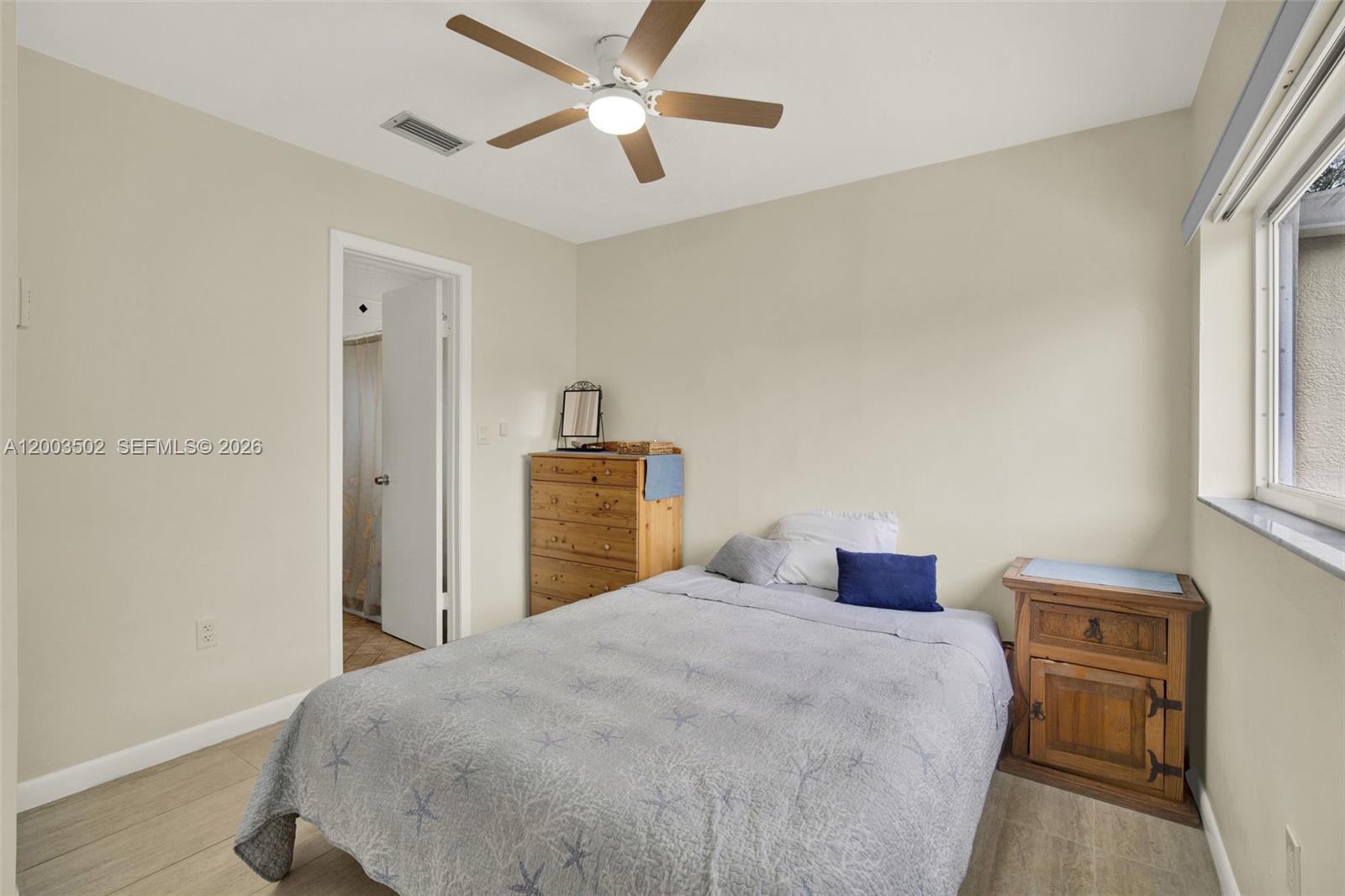 5701 Southwest 50th Terrace Miami, FL 33155 - Photo 31 of 46 a bedroom with a large bed and a chandelier