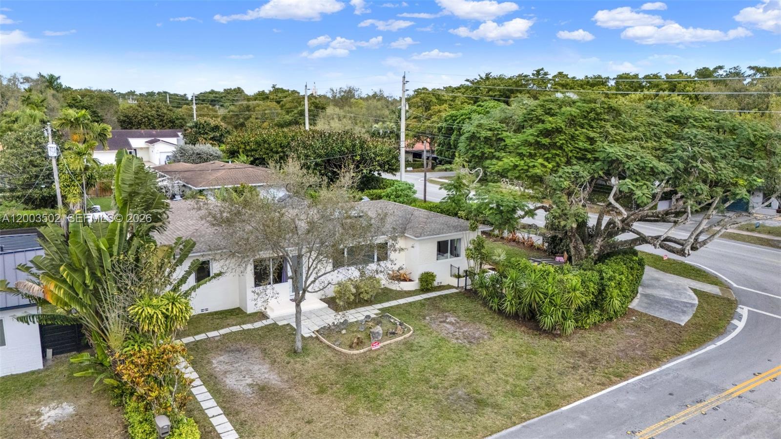 5701 Southwest 50th Terrace Miami, FL 33155 - Photo 40 of 46 a view of a garden with a building in the background