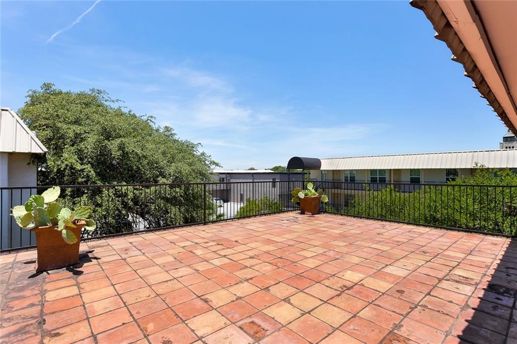 910 Duncan Lane, Unit 35 Austin, TX 78705 - Photo 18 of 20 A spacious rooftop deck, paved with rustic tile, offers an elevated outdoor retreat.
