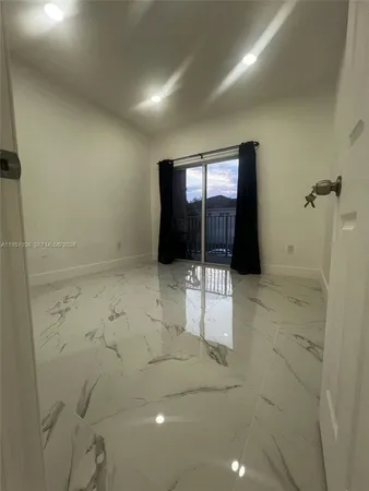 a bathroom with a sink and mirror with bathtub