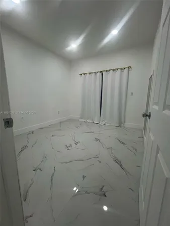 a bathroom with a granite countertop sink a toilet and a mirror