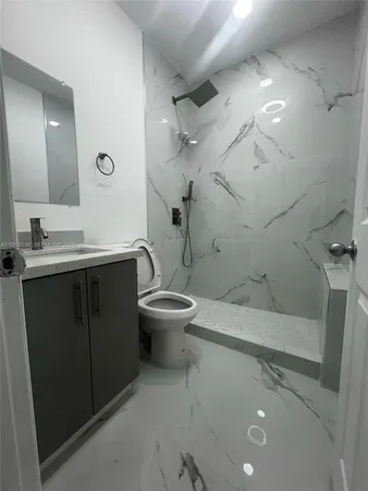 a bathroom with a sink toilet and shower