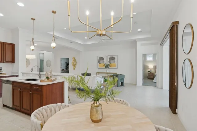 a kitchen with stainless steel appliances granite countertop a stove a sink dishwasher and a microwave with wooden cabinets