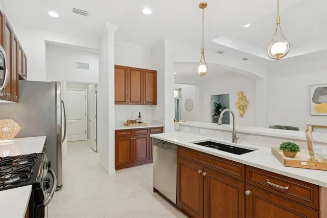 a kitchen with stainless steel appliances granite countertop a refrigerator and cabinets