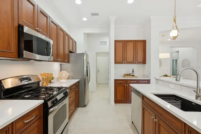 a large kitchen with a table and chairs