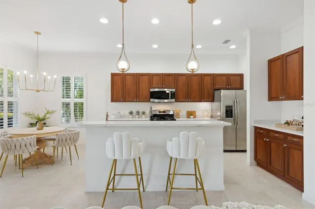 a kitchen with a table chairs microwave and cabinets