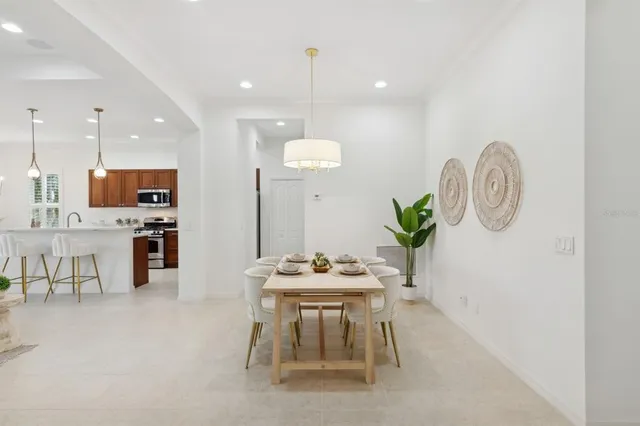 a kitchen with stainless steel appliances a stove a sink a microwave a refrigerator and cabinets