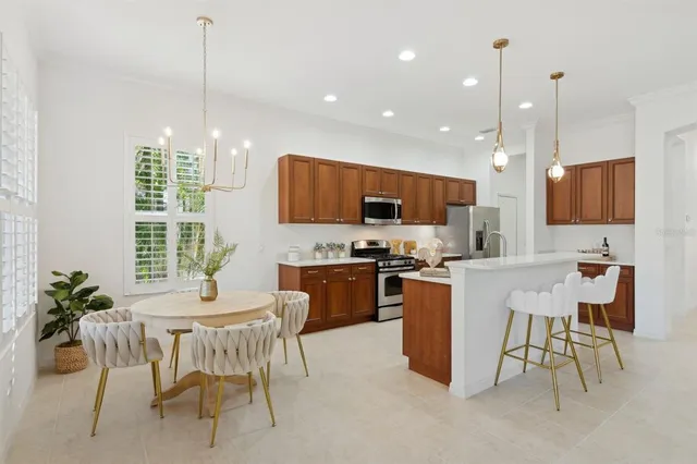 a view of a dining room with furniture and a chandelier