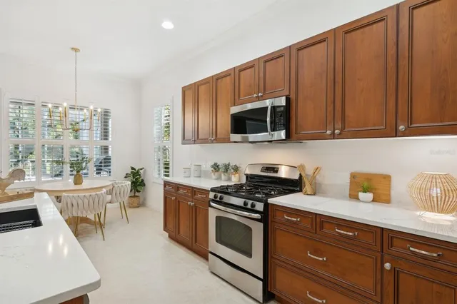 a view of a dining room with furniture a chandelier and wooden floor