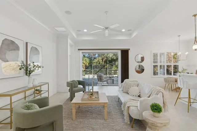 a living room with furniture and view of kitchen