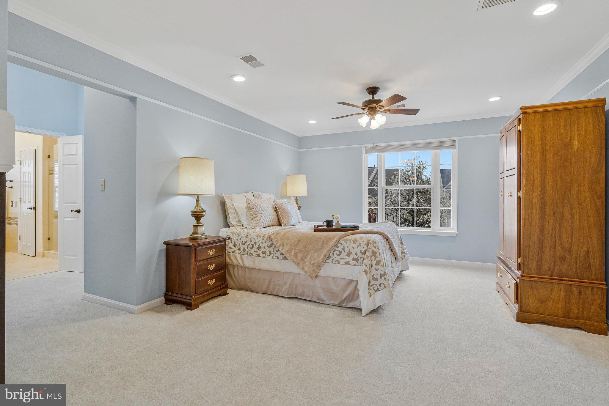 21272 Rosetta Place Ashburn, VA 20147 - Photo 27 of 58 a bed room with a bed and a chandelier