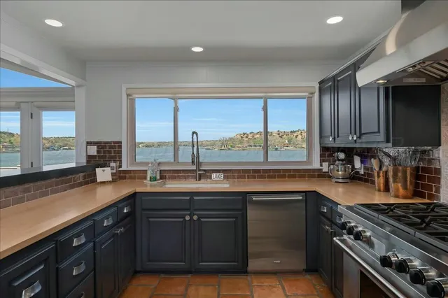 a kitchen with a sink stove and cabinets