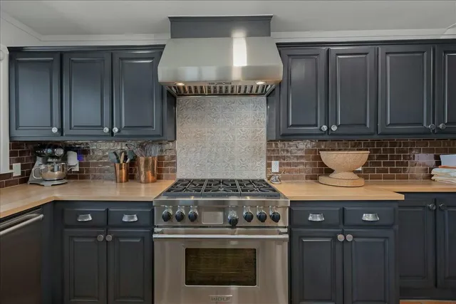 a kitchen with stainless steel appliances granite countertop a sink and cabinets