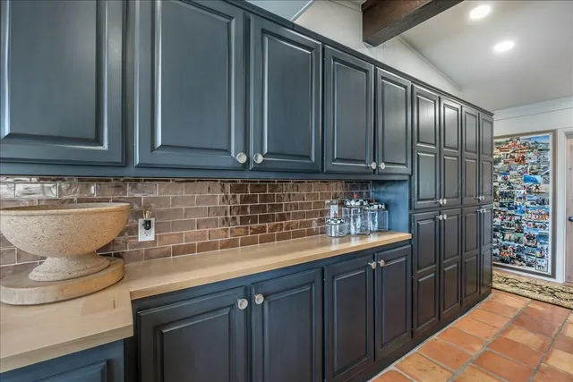a kitchen with stainless steel appliances kitchen island granite countertop a refrigerator and a sink