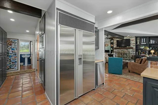 a dining room with furniture water view and large windows