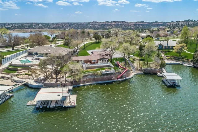 an aerial view of a house with a lake view