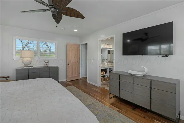a bathroom with a granite countertop toilet sink and mirror