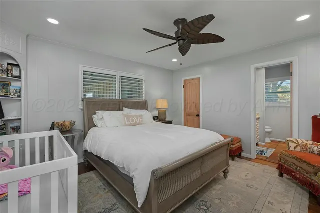a bathroom with a granite countertop sink a toilet and a mirror