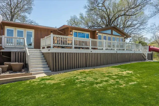 a view of a room with wooden floor and furniture