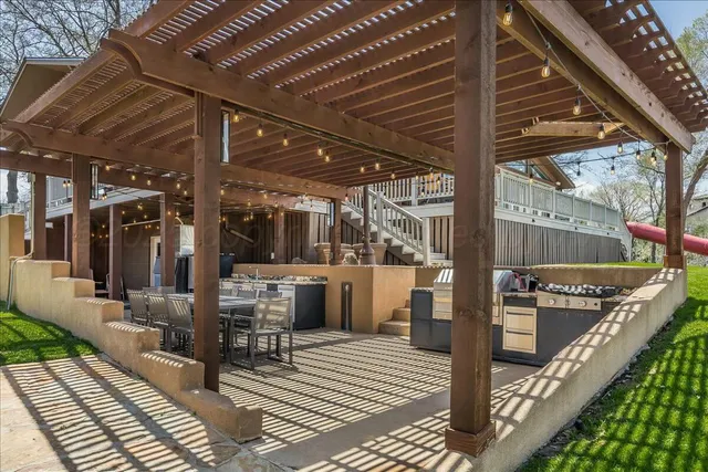 a view of a patio with table and chairs and potted plants