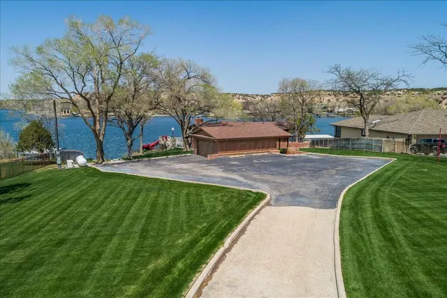 a view of a house with a yard and a street