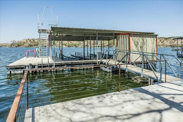 a room with lots of wooden furniture and a floor to ceiling window