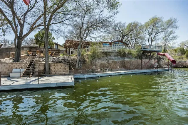 a backyard of a house with table and chairs