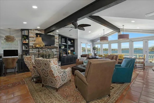 a living room with furniture and a ceiling fan