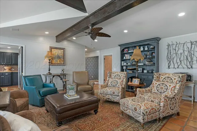 a living room with fireplace furniture and a flat screen tv
